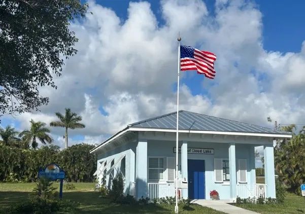Town Hall of Cloud Lake, a small light-blue building with a metal roof and an American flag.